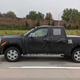 A Toyota Tacoma pickup covered in black wrappings